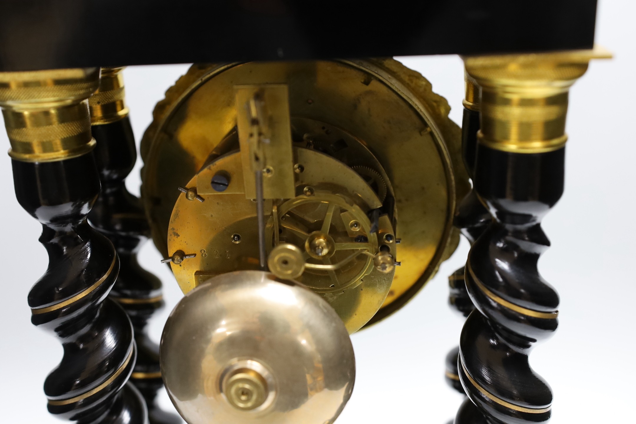 A French Napoleon III ebonised and brass inlaid portico clock. 49cm tall